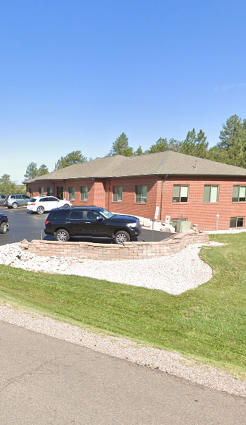 The image shows a modern dental or medical office interior with a dental chair, equipment, and a clean, professional environment.